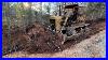 70_Year_Old_Bulldozer_Working_Hard_Along_With_New_Equipment_To_Improve_The_Driveway_Drainage_01_tm